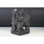 Carved Thai hard wood figurine depicting a winged deity bearing a bowl to one hand. Measures 26cm