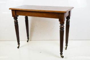 19th century Mahogany Side Table raised on turned tapering fluted legs terminating in castors,