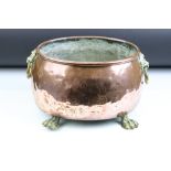 19th Century oval copper planter with twin lion mask handles, rolled upper rim, raised on four paw