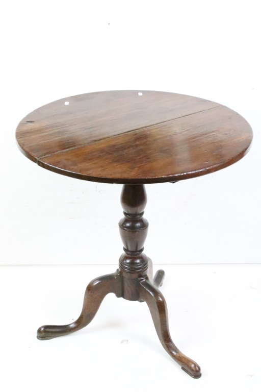 George III Oak Circular Tilt Top Supper Table raised on a turned pedestal column and three out-swept