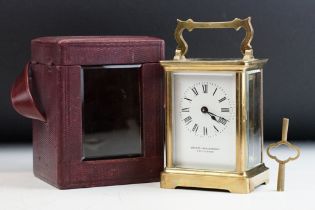 A brass cased carriage clock with bevelled glass panels, maker marked for R & Co of Paris and retail