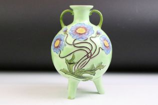 Austrian Art Nouveau majolica twin-handled vase of spherical form, with tubelined floral decoration,