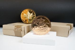 A Royal Mint coin club sovereign paperweight together with a Canadian example