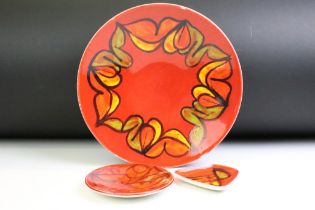 Poole Pottery 'Delphis' red ground shallow bowl (pattern no. 4, approx 26.5cm diameter), together