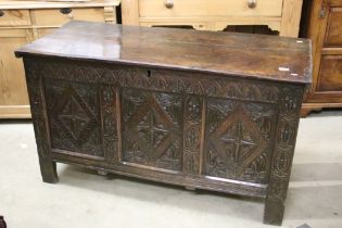 18th century Oak Coffer with three panel carved front, raised on stile legs, 130cm long x 56cm