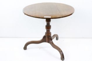 George III Oak Circular Tilt Top Supper Table raised on a turned column and three out-swept legs,