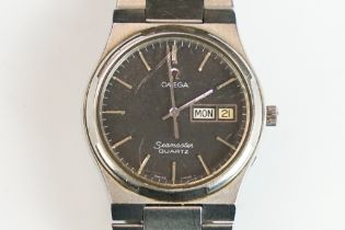 A gents Omega Seamaster quartz wristwatch, black dial with day and date function to 3 o'clock,