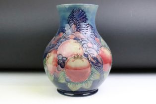 Moorcroft 'Pomegranate and Finches' pattern blue ground tube lined vase, of baluster form, after a