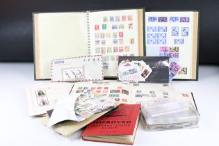 A small collection of British, commonwealth and world stamps contained within albums and together
