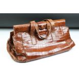 Vintage crocodile leather handbag with twin carry handles, the internal pockets housing a powder