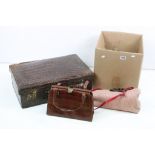 A collection of vintage handbags to include leather examples together with a suitcase.