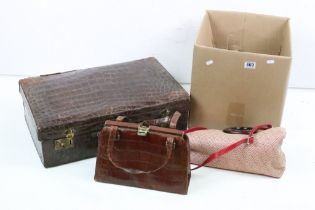 A collection of vintage handbags to include leather examples together with a suitcase.