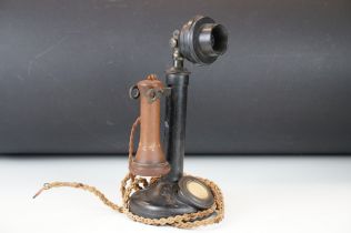 Early 20th Century candlestick phone having a black body with chorded wire. Measures 31cm tall.