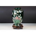 Japanese Ando style Ginbari Cloisonné Vase, decorated with flowers on a green ground, 26cm high