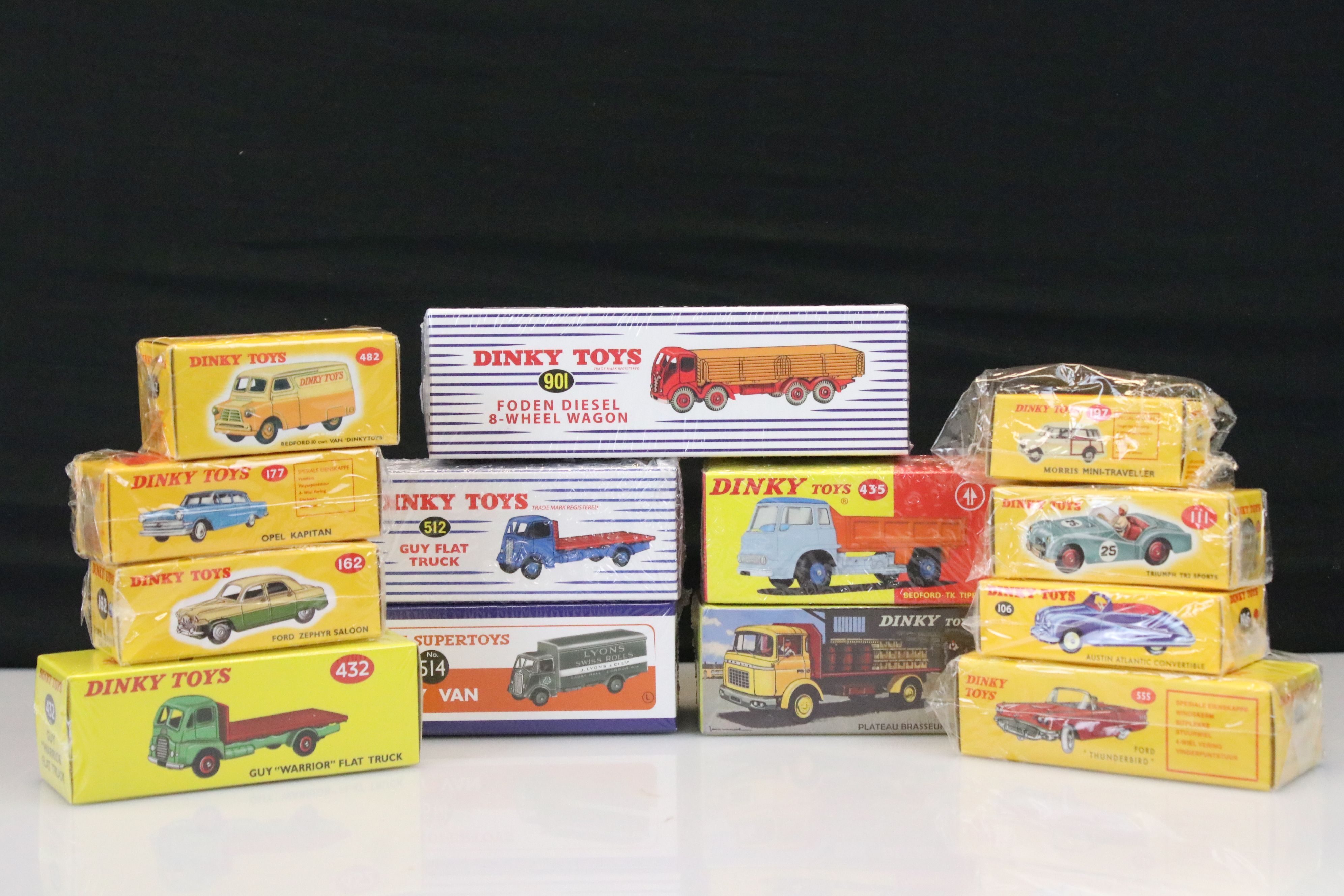 13 boxed Dinky Toys Atlas Editions diecast models to include 514 Guy Van, 512 Guy Flat Truck, 901