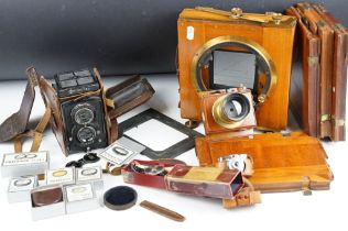A large format camera with brass lens together with a medium format Rollieflex camera and a