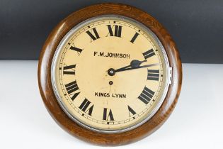 Early 20th century oak cased station style wall clock, with ' F. M. Johnson, Kings Lynn ' to dial,