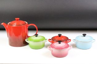 Le Creuset cerise grand teapot, together with four coloured miniature twin handled lidded dish.