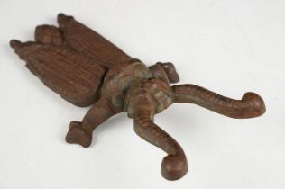 Novelty cast iron boot jack in the form of a beetle, approx 23.5cm long