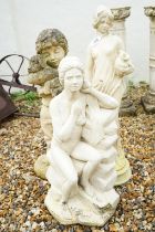 Three reconstituted stone garden sculptures to include two semi-clothed maidens and a boy holding