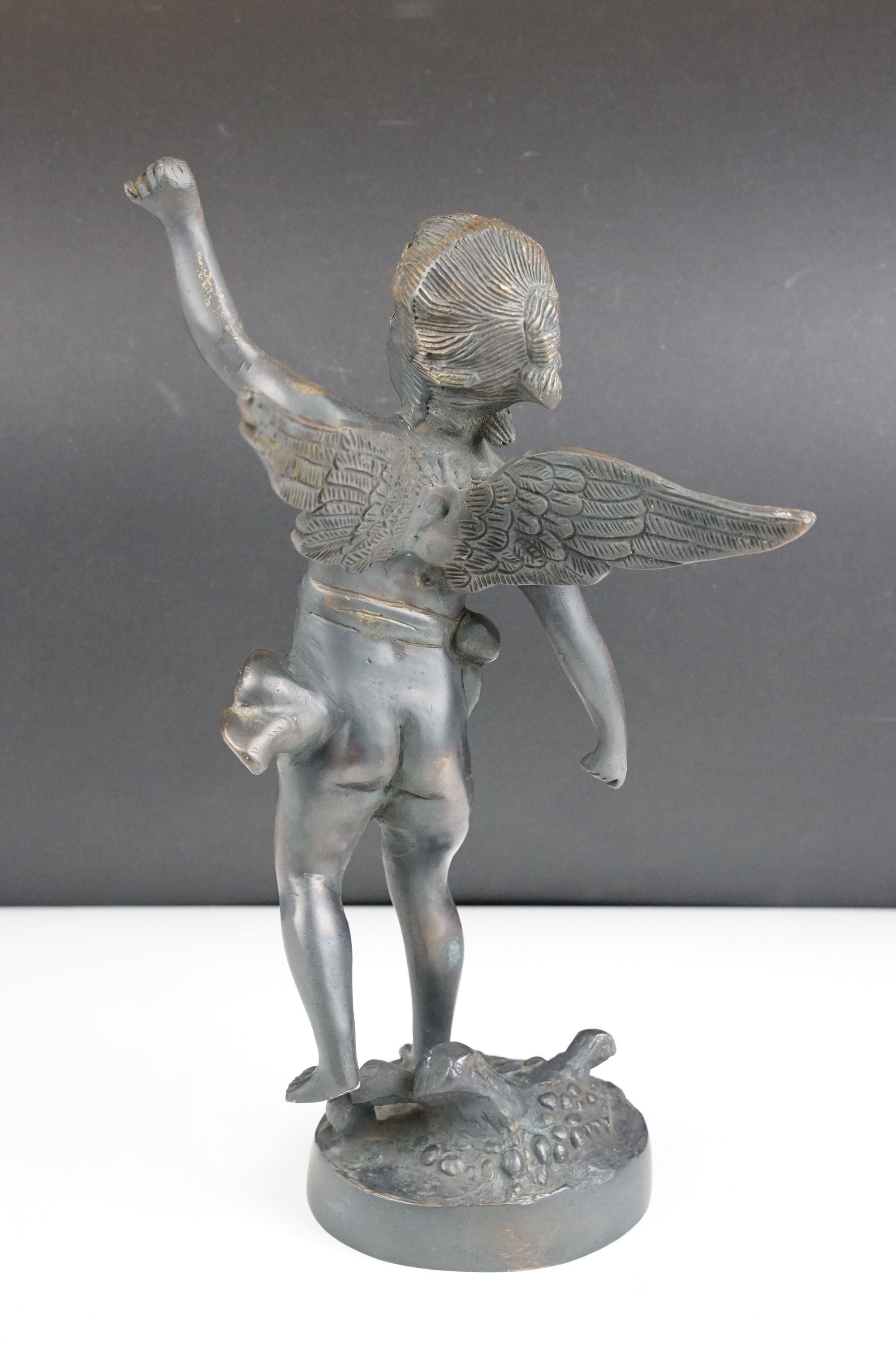Bronze Cupid / winged cherub sculpture with loin cloth, raised on a circular base of naturalistic - Image 3 of 10