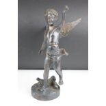 Bronze Cupid / winged cherub sculpture with loin cloth, raised on a circular base of naturalistic