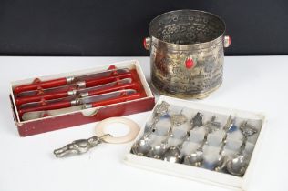 A small collection of silver plate to include a set of souvenir tea spoons, a babies rattle and
