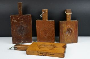 Four early 20th century wooden biscuit moulds, largest approx 33cm long