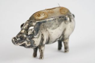 A fully hallmarked sterling silver pin cushion in the form of a pig.