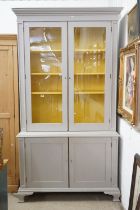 19th century Bookcase on Cupboard, later painted grey with a yellow interior, the upper section with