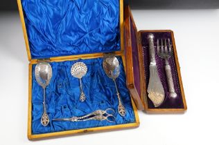 Two cased silver plated serving sets to include serving spoons, fish knife, bread fork, grape