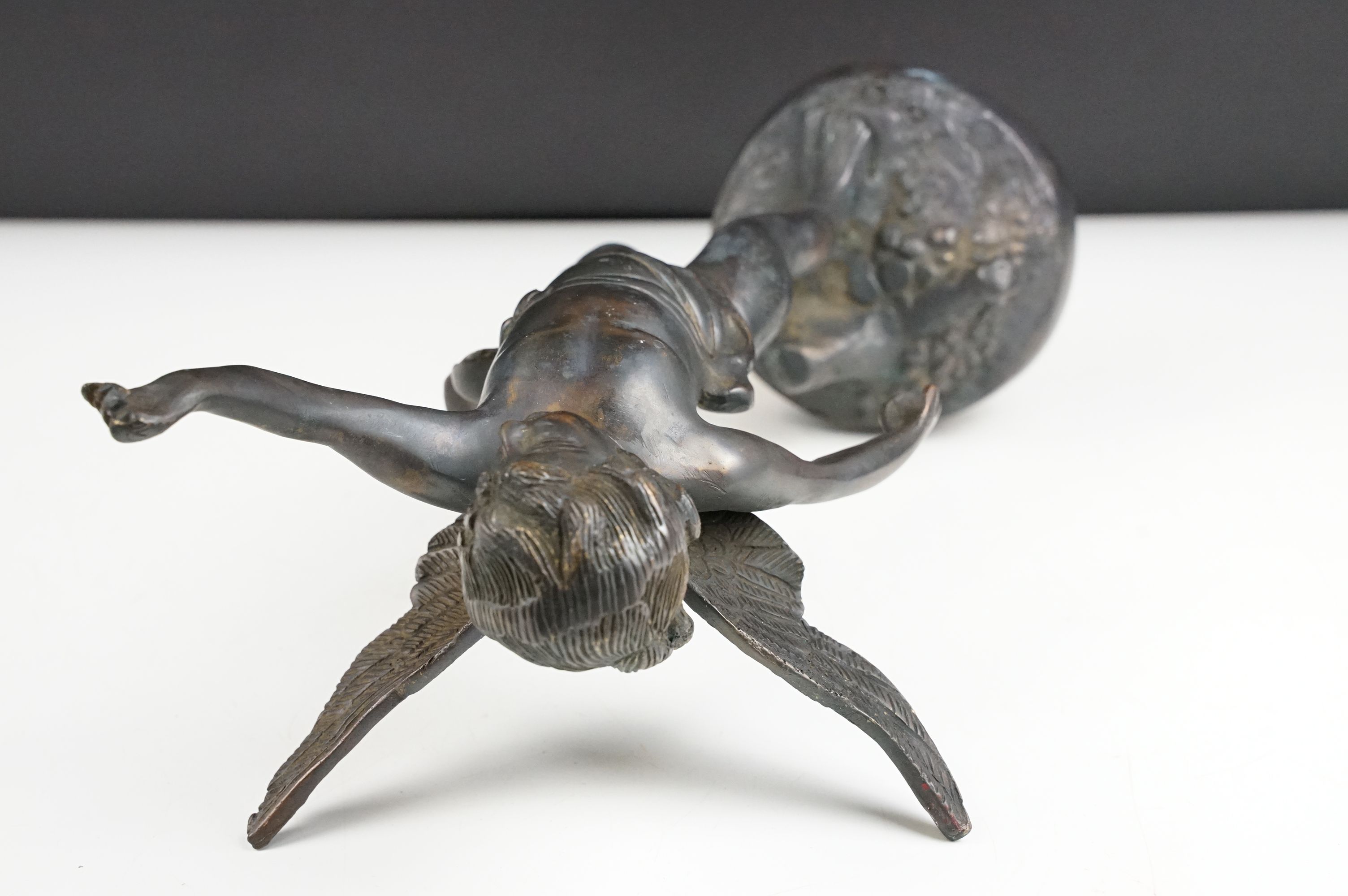Bronze Cupid / winged cherub sculpture with loin cloth, raised on a circular base of naturalistic - Image 9 of 10
