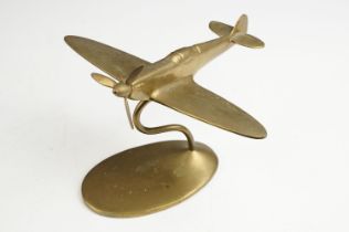 Brass desktop model of a spitfire, with rotating propellor, raised upon an oval base, 'Bates Brass