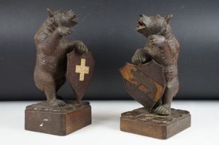 Near Pair Of Late 19th / Early 20th Century Black Forest carved wooden bears with shields, raised on