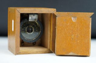 A military Naval compass set within a wooden case.