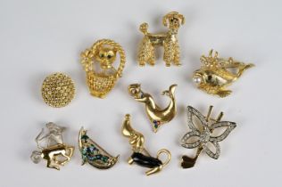 Nine Gold coloured Brooches, some enamelled, including Dogs, Star signs, Cat in a Basket, Fish,
