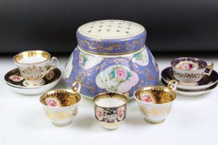 Pair of late 19th / early 20th century gilt ground cups & saucers with hand painted floral