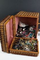 A large collection of mainly contemporary costume jewellery contained within a wicker basket.