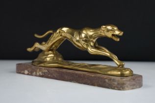 Brass model of a racing greyhound mid-stride, raised on a marble base, measures approx 24cm wide