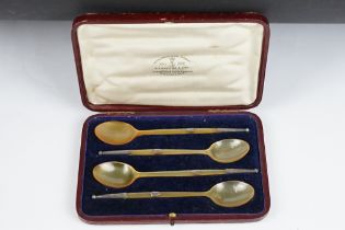 A cased set of four carved horn spoon with white metal mounts.