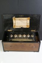 19th Century Swiss music box with eight airs, rosewood case, the inlaid hinged lid with marquetry