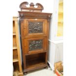 19th century Continental Carved Oak Cupboard, the pair of doors inset with bronzed panels with scnes