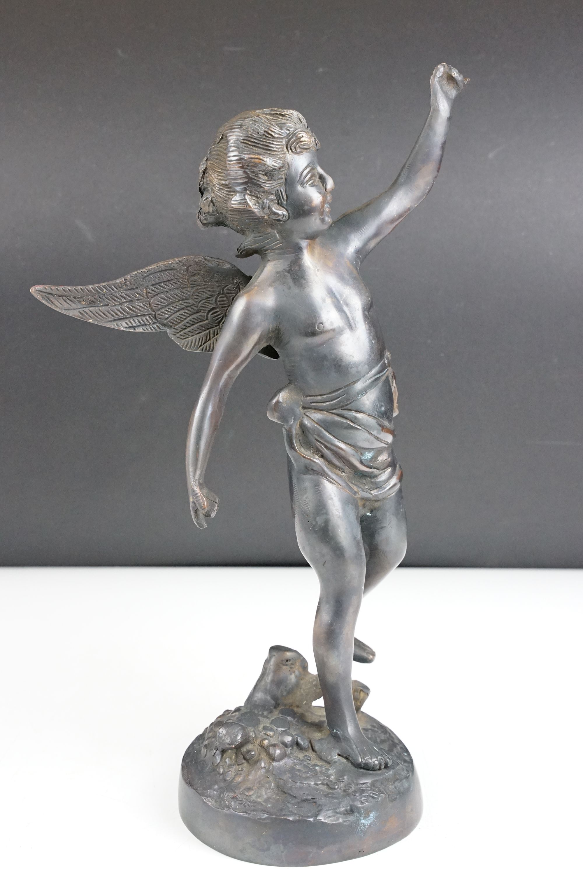 Bronze Cupid / winged cherub sculpture with loin cloth, raised on a circular base of naturalistic - Image 2 of 10