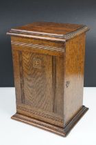 Edwardian oak smokers cabinet, the reeded door opening to a main compartment above a lower drawer