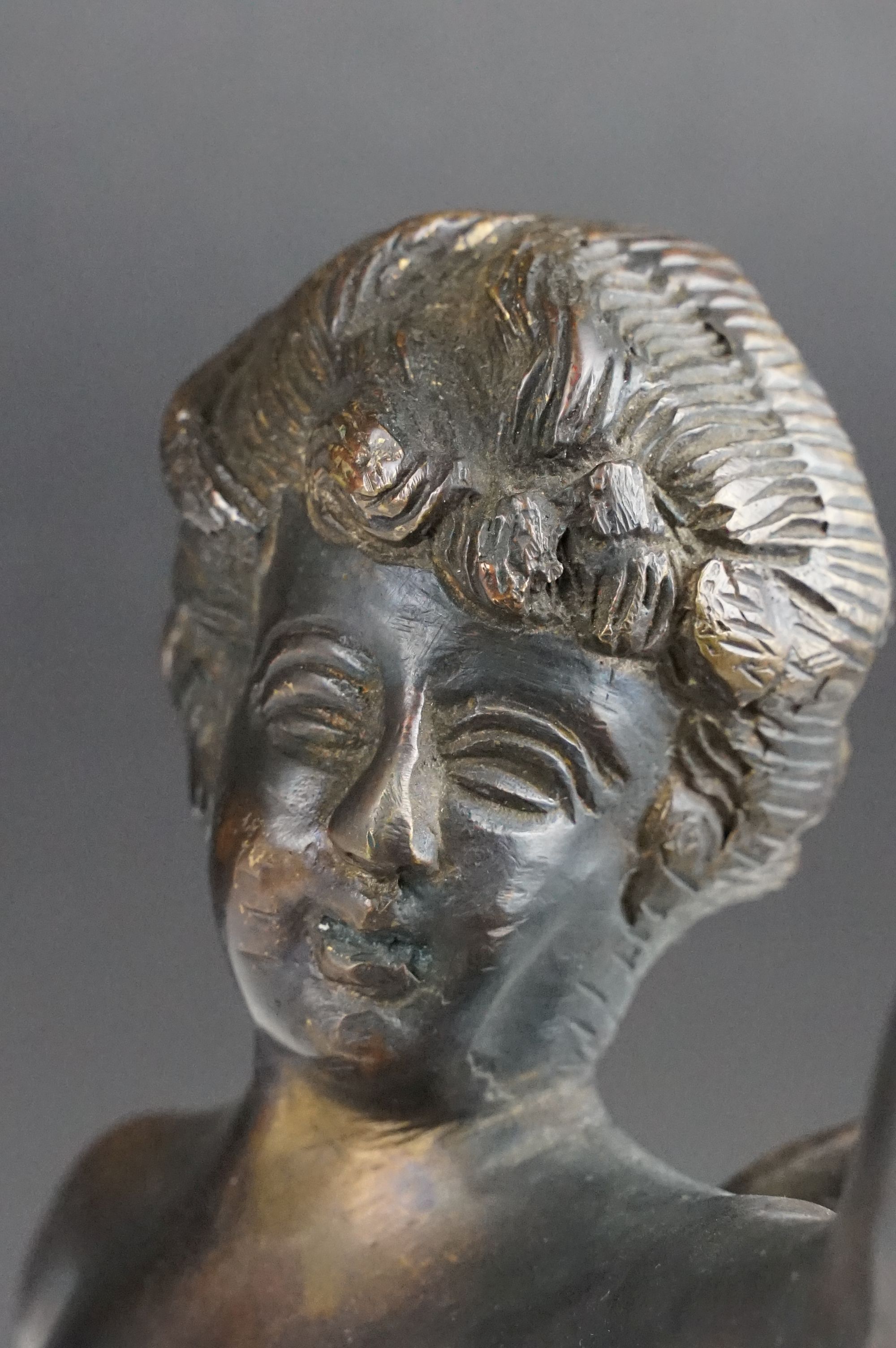 Bronze Cupid / winged cherub sculpture with loin cloth, raised on a circular base of naturalistic - Image 8 of 10