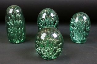 Group of four 19th Century Victorian green dump glass paperweights. Each having control bubble