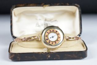An Edwardian enamelled 9ct gold half hunter wristwatch, white enamel dial with black arabic numerals