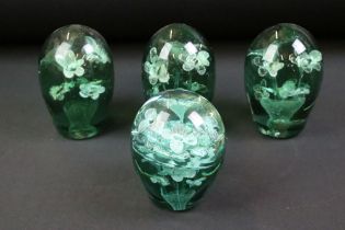 Group of four 19th Century Victorian dump glass paperweights, each having floral inclusions. Tallest