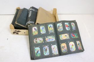 A collection of cigarette cards within six albums to include full and parts sets, issuers include