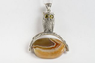 Silver Necklace in the form of an Owl sat on a revolving agate stone